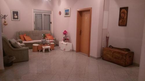 a living room with a couch and a table at Rooms Ivan-Popić in Međugorje
