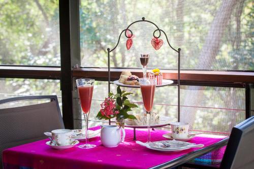 a table with a pink table cloth with champagne glasses at Mt Cotton Retreat in Mount Cotton
