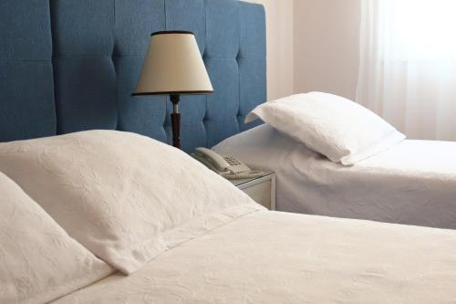 Postel nebo postele na pokoji v ubytování Hotel San Martin