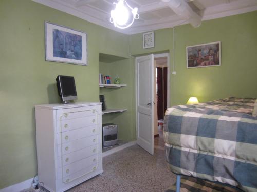 a bedroom with a bed and a dresser with a tv on it at Antica residenza La Rocca in Montefiascone