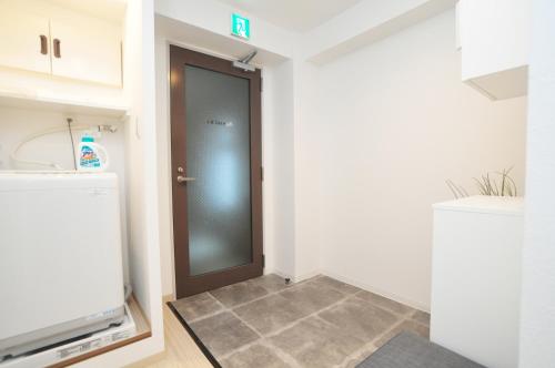 a hallway with a door in a room at guest house Sakura in Osaka