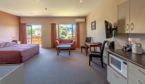 a hotel room with a bed and a desk at Waterfront motel in Blenheim