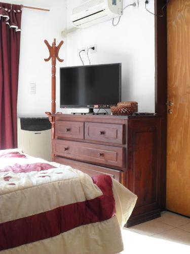 a bedroom with a dresser with a television on it at La Casona de Susana in Colón