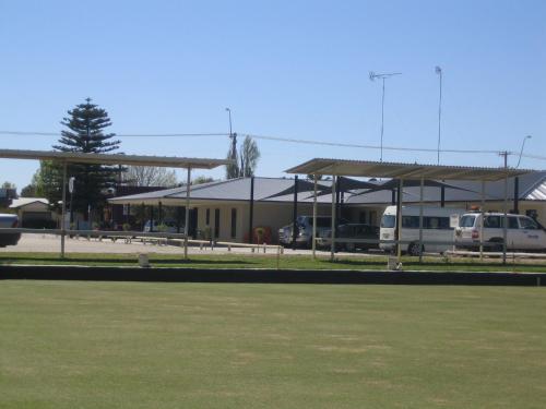 a parking lot with a building with cars parked at Balranald Club Motel in Balranald