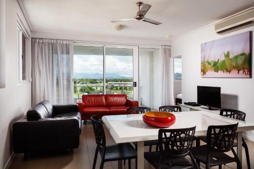 a living room with a table and chairs at Central Holborn Apartments in Townsville