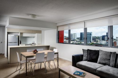 a living room with a couch and a table at Central Islington Apartments in Townsville