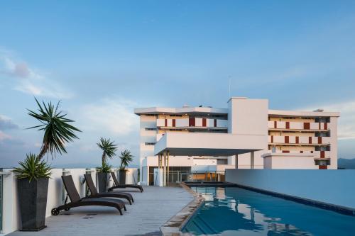 a building with a swimming pool next to a building at Central Holborn Apartments in Townsville
