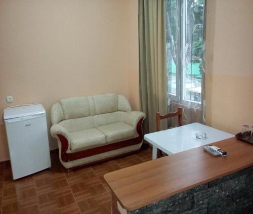 a living room with a chair and a table at Guest House Rusalka in K'obulet'i