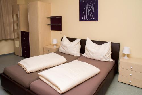 a bed with two pillows on it in a room at Welog Rast Ilz in Ilz