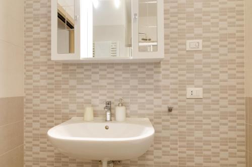 a bathroom with a white sink and a mirror at B&B and Apartments Armando Diaz in Trento