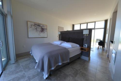 a bedroom with a large bed and a large window at The Waters in Motueka