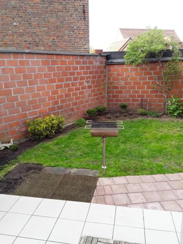 a bench in a yard with a brick wall at Wenceslas Cobergher III in Bertem