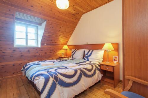 a bedroom with a large bed and a window at Das kleine Paradies in Hermagor
