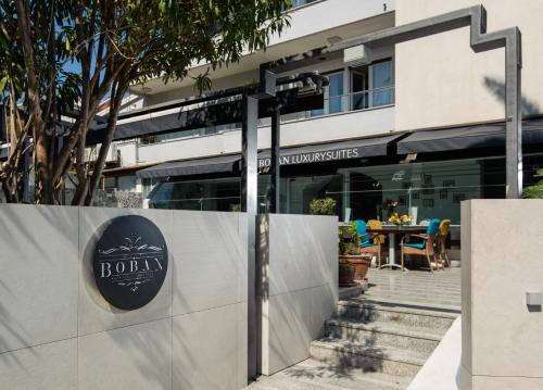 
a restaurant with tables and chairs and a building at Boban Luxury Suites in Split
