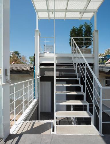 a stairway leading up to a building with a door at On the Bed Hostel in Bangkok