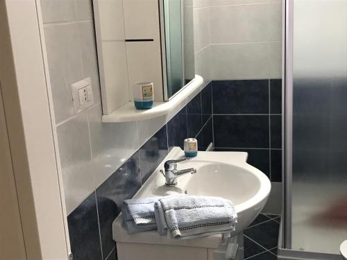 a bathroom with a sink and a mirror at Casa Gada in Torre Lapillo