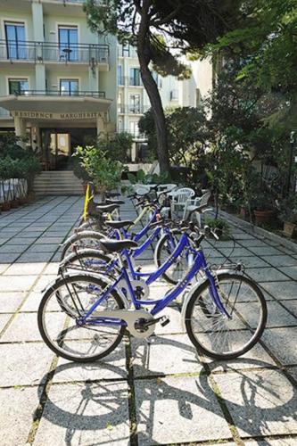 a row of blue bikes parked in front of a building at Residence Margherita in Cattolica