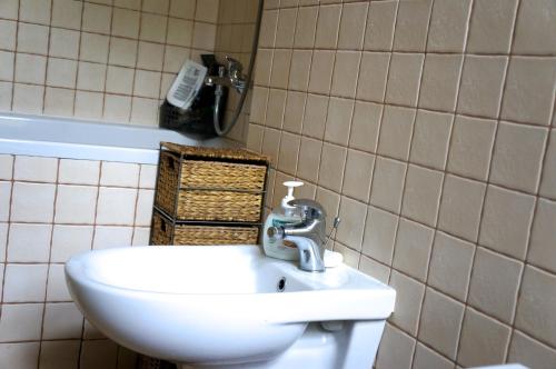 a bathroom with a sink and a phone on the wall at 90 sq.m. apartment in centre of Vilnius in Vilnius
