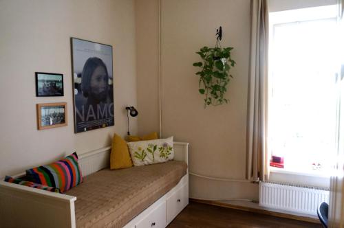 a bench in a room with a window and a windowseat at 90 sq.m. apartment in centre of Vilnius in Vilnius