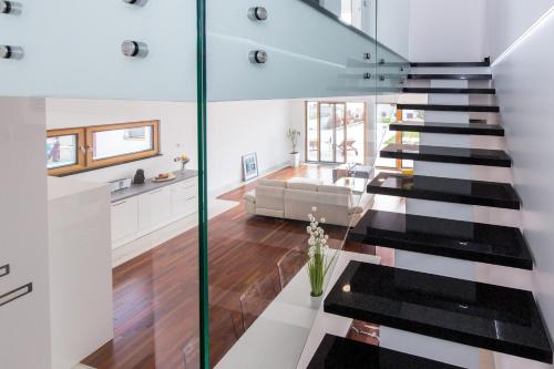 a glass staircase in a house with a living room at Villa Benić in Crikvenica