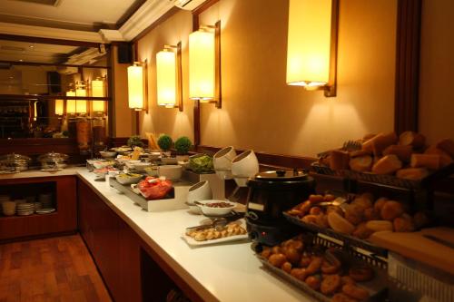 a buffet line in a restaurant with bread and food at Pera Rose Hotel - Taksim Pera in Istanbul