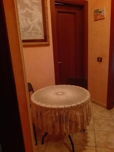 a table with a lace table cloth on it at B&B melody in Fiumicino