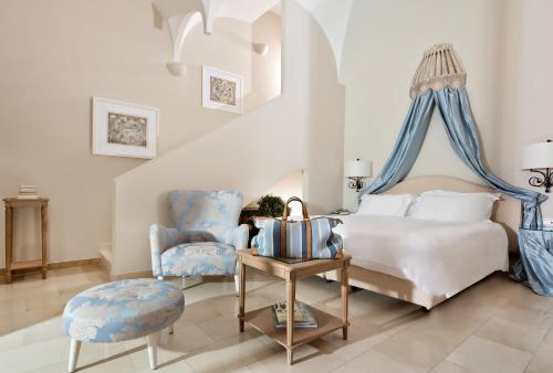 a bedroom with a bed and a chair at Villa Marina Capri in Capri