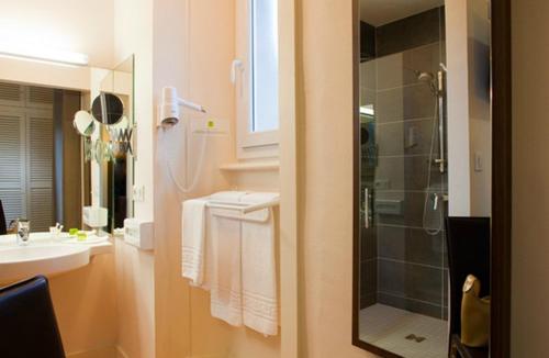 a bathroom with a shower and a sink at Logis Le Relais Saint Jacques in Saint-Léonard-de-Noblat