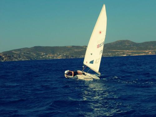 a person on a sail boat in the water at Villa Patmos Netia in Patmos