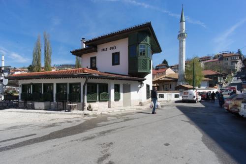 a man walking down a street in front of a building at Amazing Penthouse old town in Sarajevo