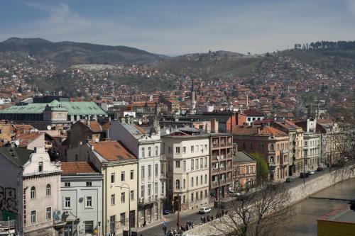 a view of a city with a river and buildings at Amazing Penthouse old town in Sarajevo