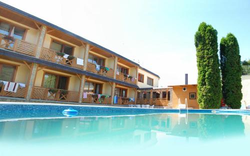 a large swimming pool in front of a building at Hotel Ranč u Edyho in Námestovo