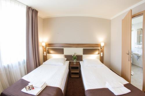 a hotel room with two beds and a window at Hotel Diament Zabrze - Gliwice in Zabrze