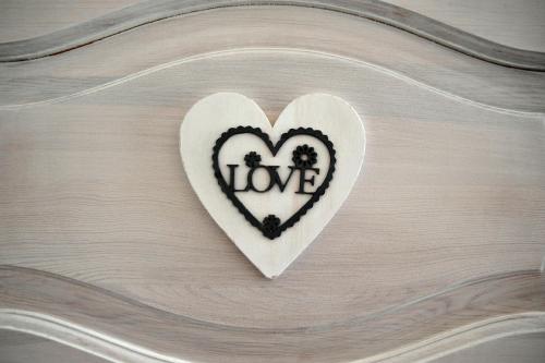 a heart with the word love written on it at Hotel Ottaviano in Świnoujście