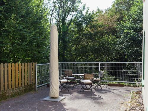 a statue of a column with chairs and a table at Chic apartment in Hessisch Oldendorf in Zersen
