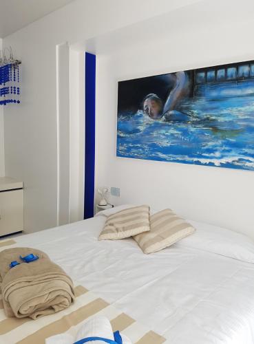 a white bed with two pillows on top of it at San Giorgio Modica Hotel in Modica