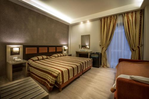 Postel nebo postele na pokoji v ubytování Rex Hotel