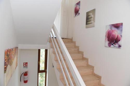 a staircase in a house with paintings on the walls at B&B Il Canto Del Mare in Pulsano