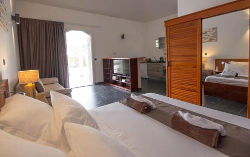 a hotel room with a bed and a living room at Villa La Ressource in Le François