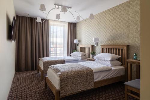 Postel nebo postele na pokoji v ubytování Hotel Sinchronas