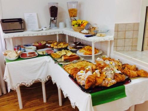 a table with many different types of food on it at Hotel 2000 in Fabriano
