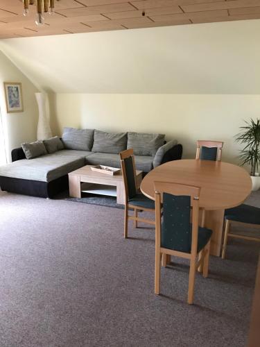 a living room with a couch and a table at Hotel Tannenhof in Steinen