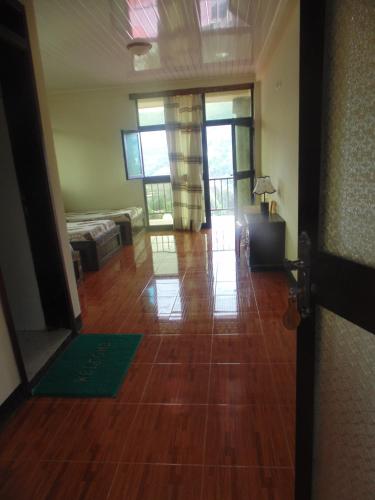 a living room with a hard wood floor and a door at Torpedo Hotel in Lalībela