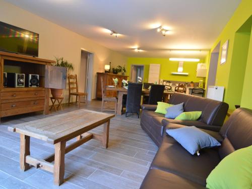 a living room with a couch and a coffee table at Cozy Holiday home in Theux in Theux