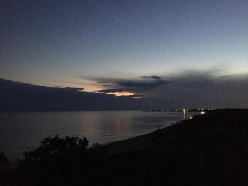 a sunset over a body of water with a beach at B&b VICTORIA in Porto Cesareo