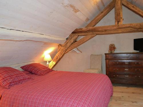 a bedroom with a bed and a dresser in a attic at Romantic Loire Hideaway in Brion
