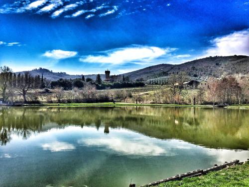 a view of a lake with mountains in the background at Tenuta Lupinari in Bucine