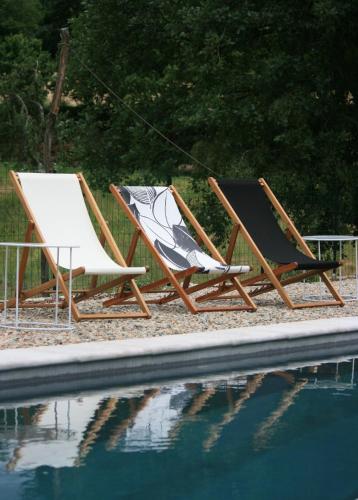 two lounge chairs sitting next to a swimming pool at Artemisia Boutique Hotel in Bastelica