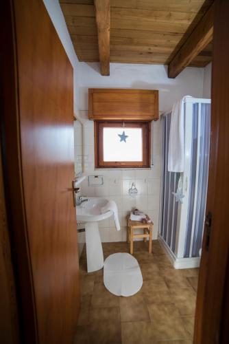 a bathroom with a sink and a window at La Valle Delle Najadi in Vietri sul Mare