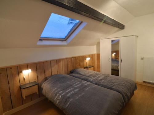 a bedroom with a bed with a window in it at Modern Holiday Home in Sourbrodt with Private Pool in Sourbrodt